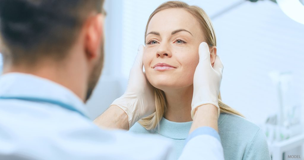 A woman receives an exam to determine what can be achieved with a non surgical rhinoplasty.